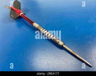 Dart on a blue table Stock Photo