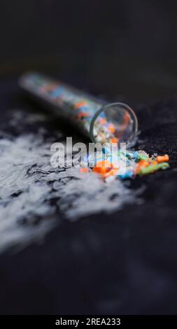 Vector macro shot of a test tube full of micro plastics collected from the beach. Concept of water pollution and industrial waste management. Stock Photo