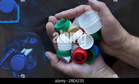 Vertical macro shot of a test tube full of micro plastics collected from the beach. Concept of water pollution and industrial waste management. Stock Photo