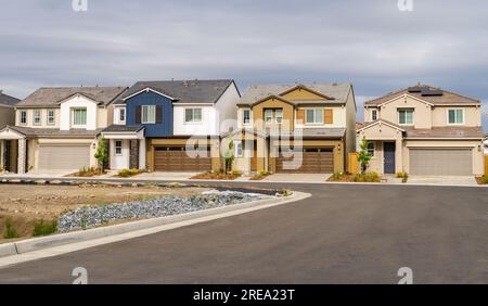 Row of single family homes on a cloudy day Stock Photo
