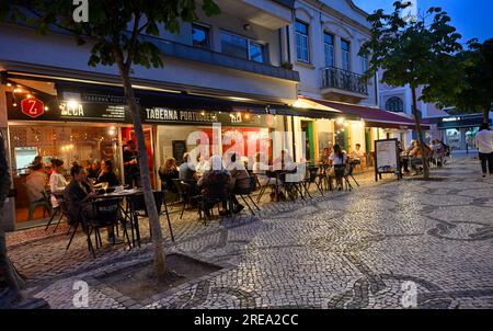 Night life, eating outside restaurants along partly pedestrianized street in Aveiro City Center, Portugal Stock Photo