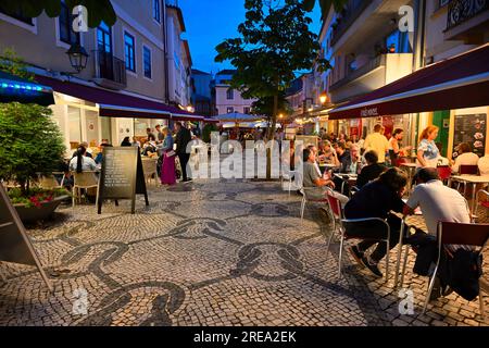 Night life, eating outside restaurants along partly pedestrianized street in Aveiro City Center, Portugal Stock Photo