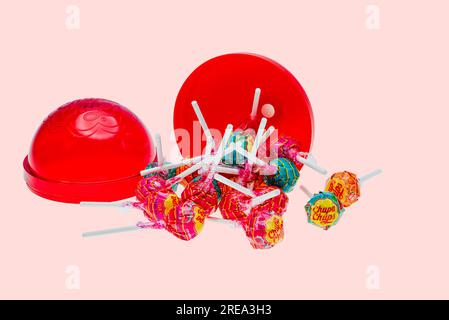 Close-up view of open big plastic chupa chups package  several caramels isolated on pink background. Stock Photo