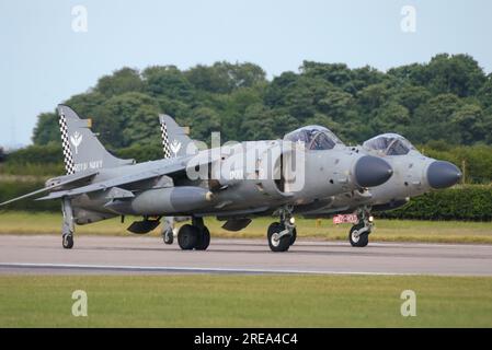 Pair of BAe Sea Harrier FA2 fighter jet planes lining up to take off to display at the RAF Waddington International Airshow 2005, UK. Harriers Stock Photo