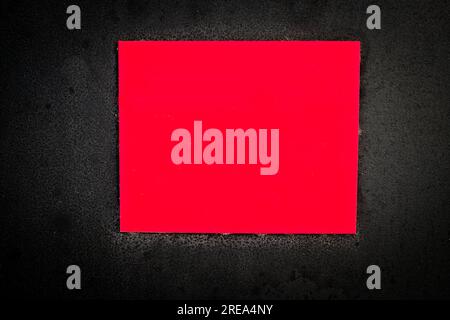 Empty red warning plate on a black background. Stock Photo