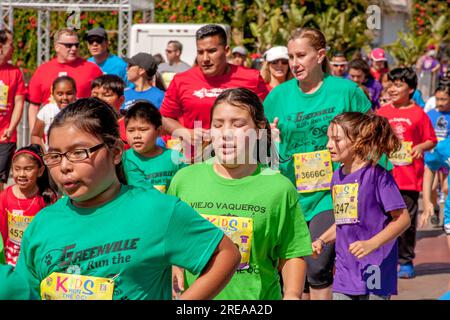 Costa Mesa, California, USA. 5th May, 2018. 10-year-old multiracial runners and adults are looking tired at a community track event in Costa Mesa, CA. (Credit Image: © Spencer Grant/ZUMA Press Wire) EDITORIAL USAGE ONLY! Not for Commercial USAGE! Stock Photo