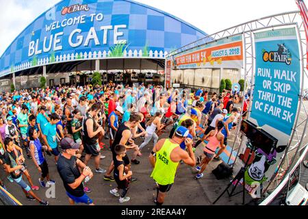 Costa Mesa, California, USA. 5th Aug, 2018. Participants in a county fair 5K foot race crowd at the starting gate in Costa Mesa, CA. (Credit Image: © Spencer Grant/ZUMA Press Wire) EDITORIAL USAGE ONLY! Not for Commercial USAGE! Stock Photo