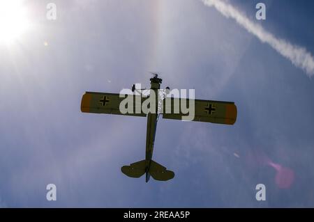 Fieseler Fi-156 Storch. Morane Saulnier MS502 Cricket plane, flying overhead with sunburst and ring Stock Photo