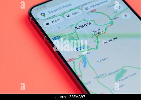 New York, USA - July 21, 2023: Ankara car traffic distribution in google maps on smartphone screen close up view with red background Stock Photo