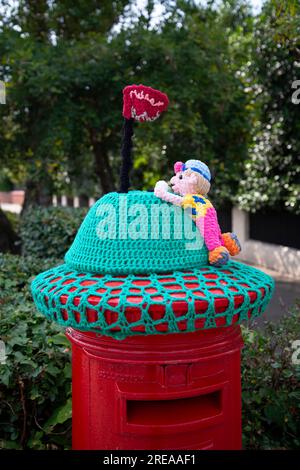 A knitted post box topper celebrating the 2023 Open Golf Championship, Hoylake, NW UK Stock Photo