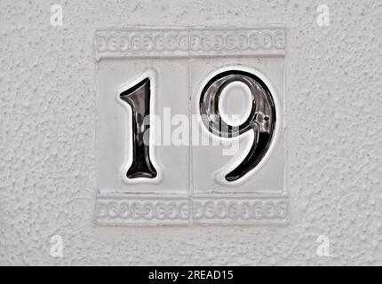 Number 19, nineteen, black digits on white background, centered. Stock Photo