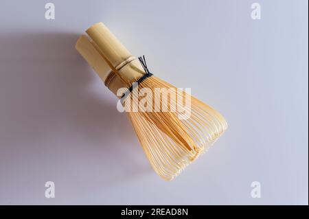 Close-up of bamboo green tea whisk. Bamboo matcha whisk. View from above. White background. Stock Photo