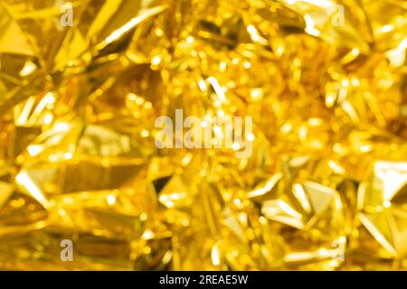 defocused crumpled gold foil, fashion texture background. High quality photo Stock Photo