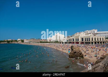 Biarritz beach full of people bathing and sunbathing on a summer afternoon. Stock Photo