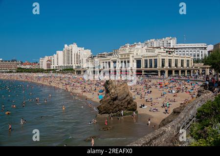 Biarritz beach full of people bathing and sunbathing on a summer afternoon. Stock Photo