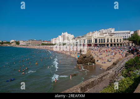 Biarritz beach full of people bathing and sunbathing on a summer afternoon. Stock Photo