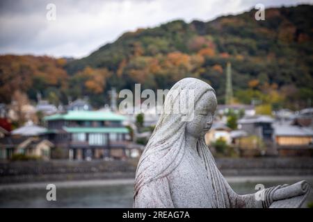 Statue of a Japanese novelist, poet and lady-in-waiting at the court in the Heian Era Murasaki Shikibu at Uji River. The author of The Tale of Genji Stock Photo