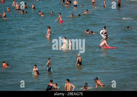 Many people bathing on a beach. Stock Photo