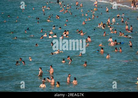 Many people bathing on a beach. Stock Photo