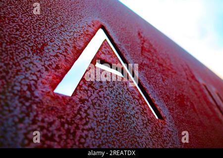 Single capital letter A cut out in rusty metal plate, angled perspective view. Stock Photo