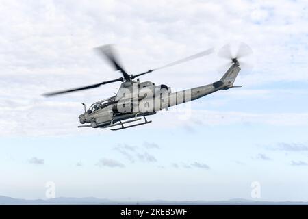 CORAL SEA (July 23, 2023) An AH-1Z Cobra helicopter from Marine Medium Titltrotor Squadron (VMM) 265 takes off from the flight deck of the amphibious transport dock ship USS Green Bay (LPD 20) to participate in a combined joint live-fire exercise, as part of Exercise Talisman Sabre, July 23. Talisman Sabre is the largest bilateral military exercise between Australia and the United States advancing a free and open Indo-Pacific by strengthening relationships and interoperability among key allies and enhancing our collective capabilities to respond to a wide array of potential security concerns. Stock Photo