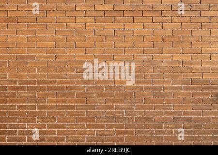 Full frame texture background of a grungy antique orangish brown brick wall in a running bond brickwork style Stock Photo