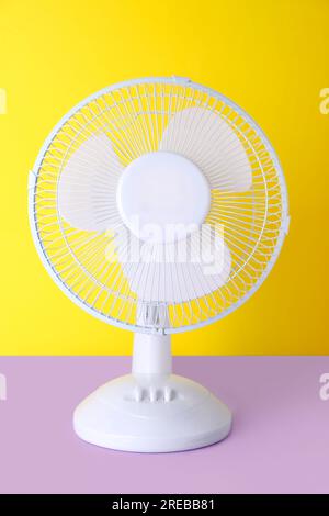 Electric fan on yellow background Stock Photo