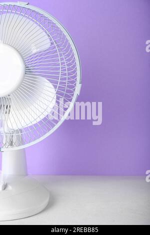 Electric fan on lilac background Stock Photo