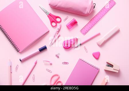 Different school stationery and notebooks on pink background Stock Photo