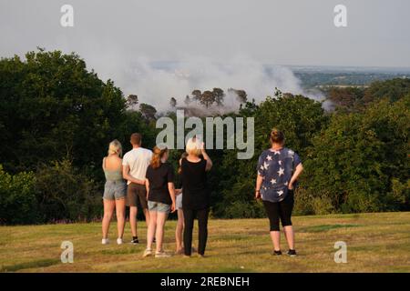 File photo dated 18/07/22 of people watch a large wildfire that has broken out in woodland at Lickey Hills Country Park on the edge of Birmingham. The hot, dry summer that saw 40C temperatures recorded in the UK for the first time ever with wildfires destroying houses and trees withering in the heat was a 'sign of things to come' for the UK's climate, scientists have said. Issue date: Thursday July 27, 2023. Stock Photo