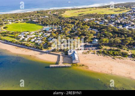 Aerial view of a t shaped jetty crossing a sandy beach to a coastal river at Barwon Heads in Victoria, Australia Stock Photo