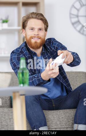 Portrait of an emotional man with a joystick in his hands. ESports ...