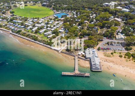 Aerial view of a t shaped jetty crossing a sandy beach to a coastal river at Barwon Heads in Victoria, Australia Stock Photo