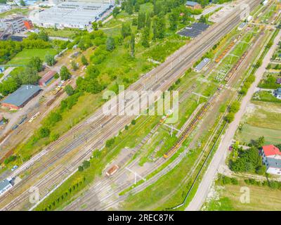 Cargo trains close-up. Aerial view of colorful freight trains on the railway station. Wagons with goods on railroad. Heavy industry. Industrial concep Stock Photo