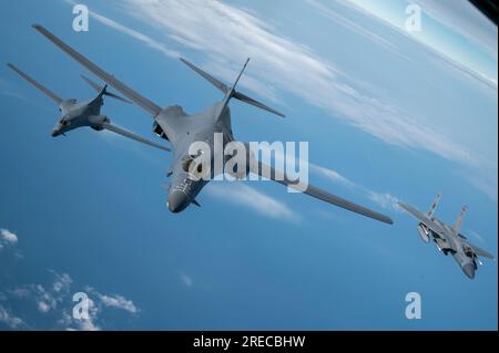 A U.S. Air Force F-15C Eagle intercepts two B-1B Lancer bombers on the east coast of North America on June 26, 2023.Photo by Master Sgt. Bryan Hoove Stock Photo