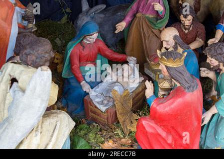 Christmas Manger scene with figurines including Jesus, Mary, Joseph, sheep and magi. Stock Photo