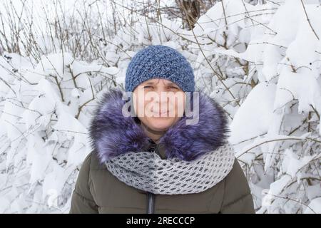 Beautiful girl in fashionable winter clothes blows snow from the palms of  her hands. Joy to the first snow .Young blonde in a white hat in a snowy  Stock Photo - Alamy