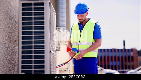 Industrial Air Conditioning Technician. HVAC Cooling System Repair Stock Photo