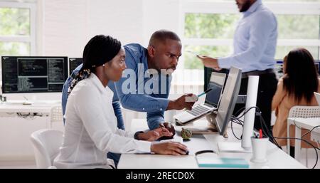 African Business Team Working On Computer. Software App Development Stock Photo