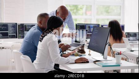 African Business Team Working On Computer. Software App Development Stock Photo