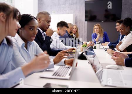 Tired Young Businessman Yawning At His Workplace Stock Photo