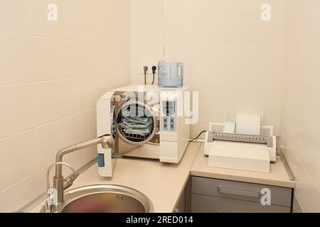 Sterilizing medical instruments in autoclave. Dental office. Selective focus. Sterile dental tools Stock Photo