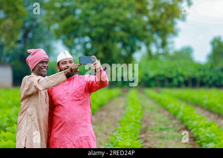 Indian farming, two farmer standing in farm , happy farmer , farmer and worker Stock Photo