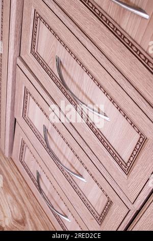 Wooden chest of drawers with metal handles close up Stock Photo