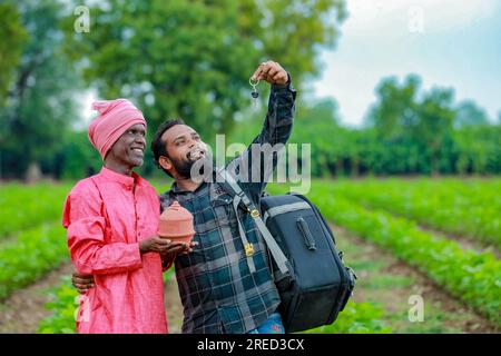 Indian farming, farmer saving , bank employee showing key Stock Photo