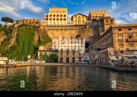 The Grand Hotel Excelsior Vittoria bathed in golden light viewed from Sorrento Harbour on the Bay of Naples in the Campania Region of Southwest Italy Stock Photo