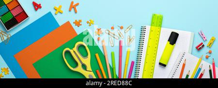 Back to school. Panoramic education banner. Top view, flat lay. Colorful supplies on table, colored paper. Children's creativity concept. Preschool st Stock Photo