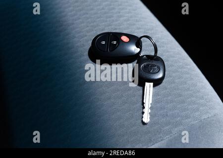 Car keys sit on car seat. Stock Photo