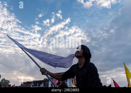 A Shia Muslim mourner waves a religious flag during a procession on the ...