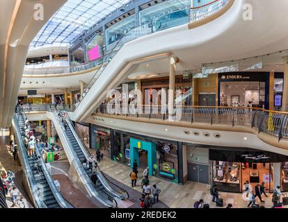 Busy scene with shoppers on escalators inside the Bullring Shopping Mall in Birmingham, West Midlands, UK on 23 July 2023 Stock Photo